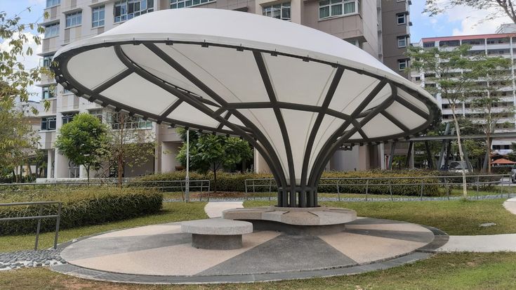 a large white structure sitting in the middle of a park