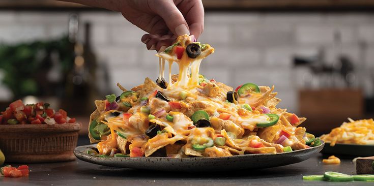 a person is dipping some food into a bowl