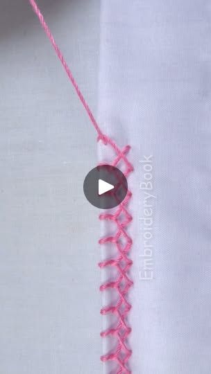 the video is showing how to make a crochet stitch on a white shirt