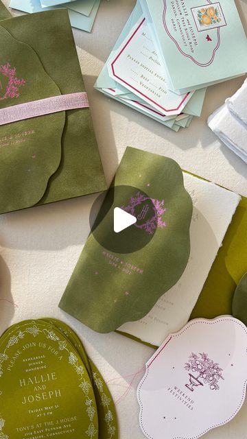 many different types of wedding cards and envelopes on a table with ribbons around them