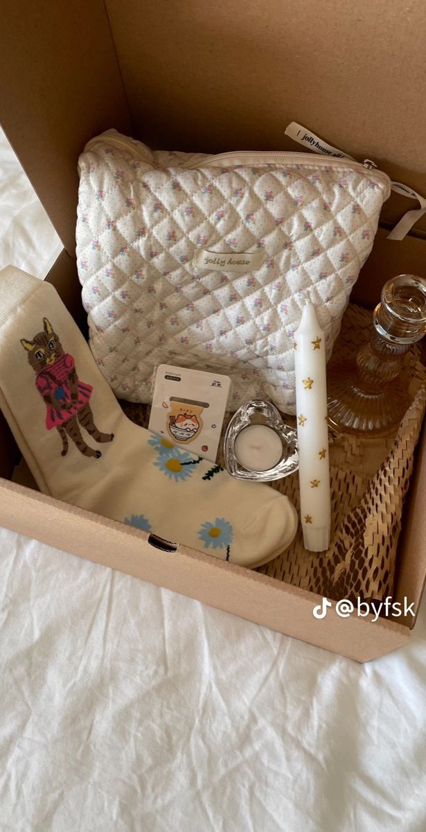 an open box with items inside on a bed