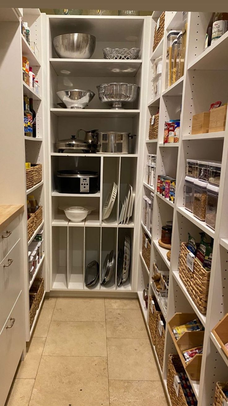 an organized pantry with white shelving and lots of food