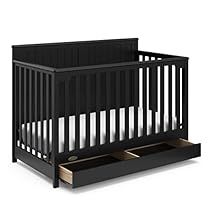 a black crib with two drawers on the bottom and an open drawer underneath it