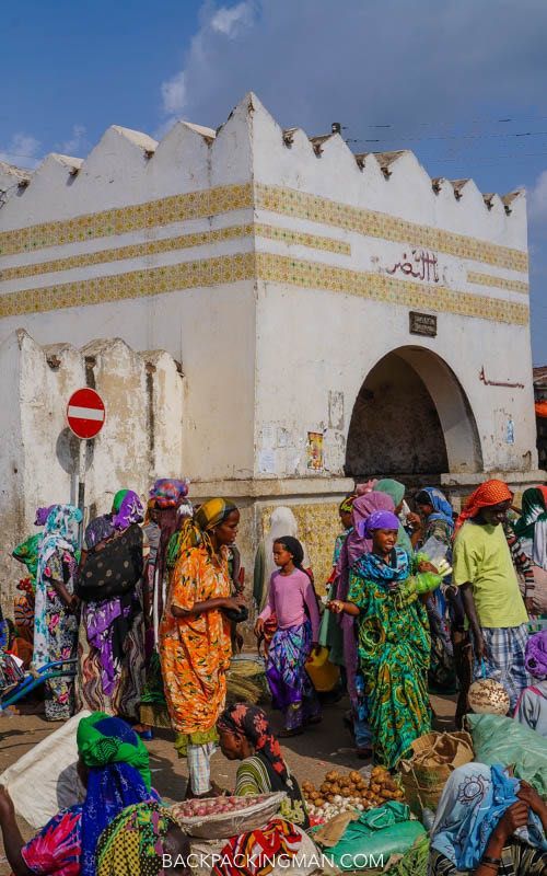 a group of people standing in front of a white building with the words step back in time in haar