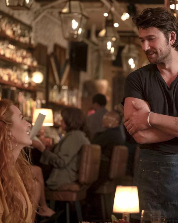 a man standing next to a woman in a restaurant