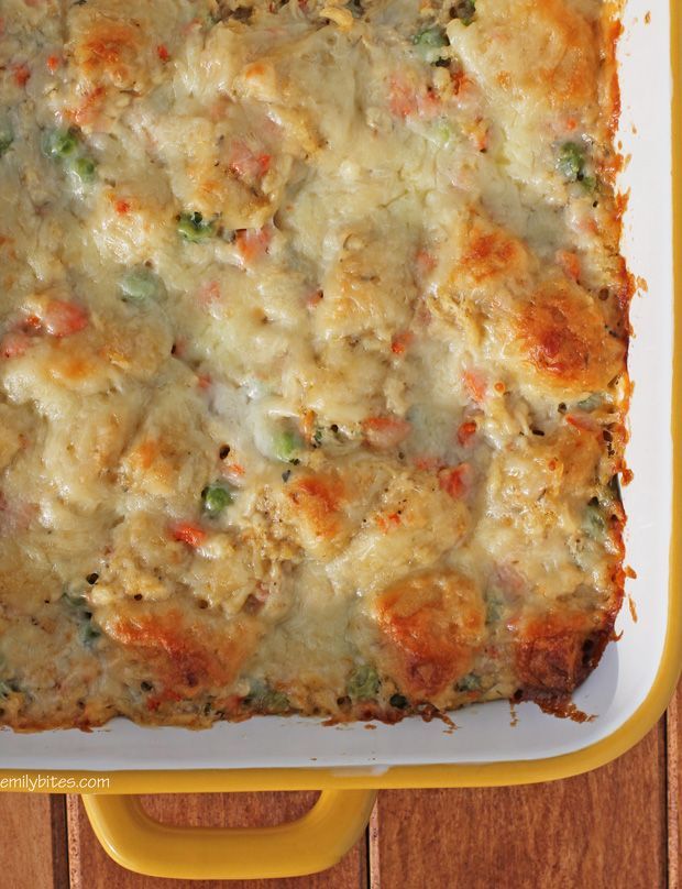 a casserole dish with meat and vegetables in it on a yellow tray next to a wooden table