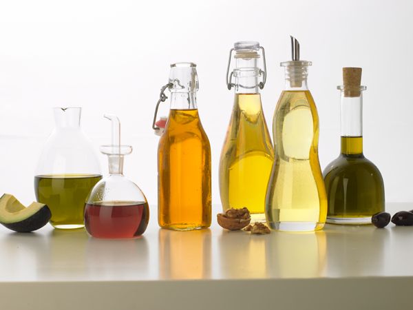 several different types of olive oil in glass bottles