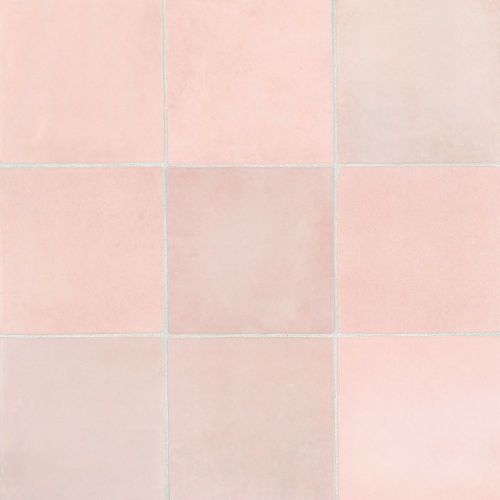 a pink tiled wall with white squares on it