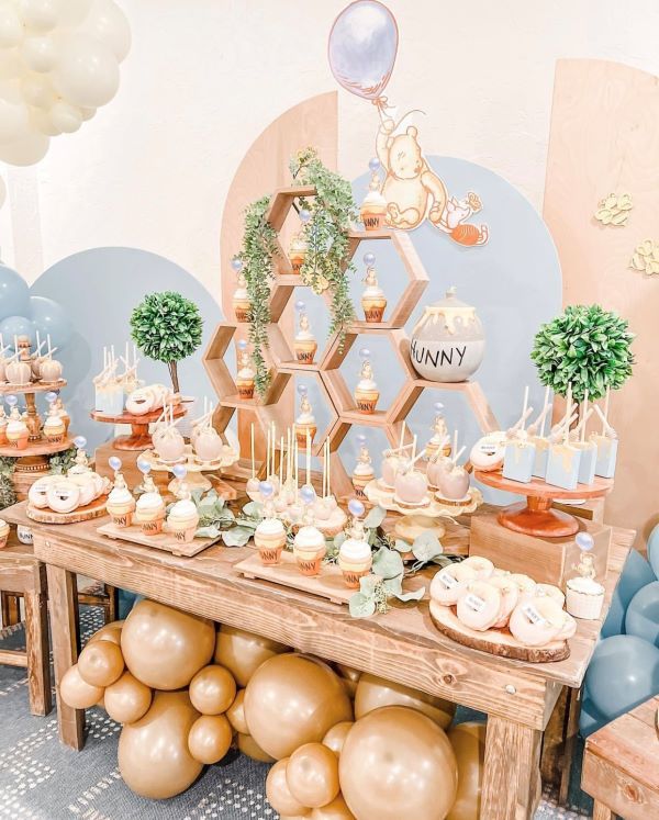 a table topped with lots of desserts and balloons