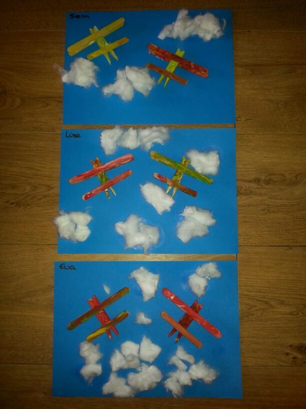 paper airplanes flying in the sky with clouds