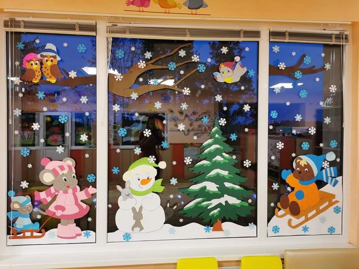 the window is decorated with snowmen, bears and christmas trees in front of it