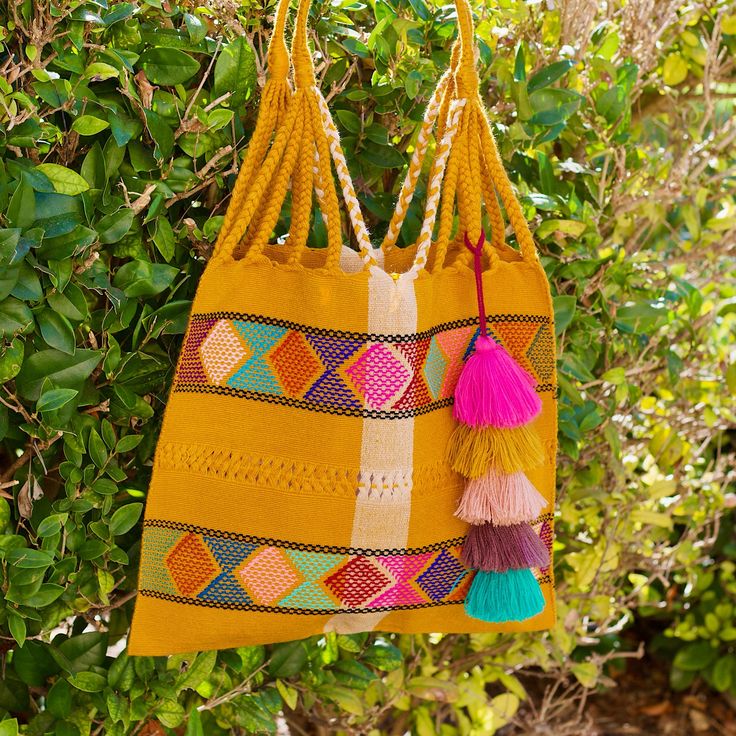 This unique bag is beautifully made on a waist loom, (Telar de Cintura) by artisans from Chiapas México.Each bag is individually handwoven with a unique colors and designs . There is not other like it! Use this reusable and eco-friendly, 100% cotton loom tote bag as a shopping bag for farmer's markets . Dress it down with a t-shirt and jeans or shorts! or to add a boho vibe to any outfit. Details: Tote measurements: 14 x 16.5 inch Handle drop: 10" Material: 100% Cotton Main color : Mustard All i Eco-friendly Multicolor Festival Bag, Yellow Artisan Bags For Daily Use, Yellow Artisan Bag For Everyday Use, Artisan Yellow Bag For Everyday Use, Yellow Bohemian Rectangular Bag, Yellow Rectangular Bohemian Bag, Bohemian Yellow Rectangular Shoulder Bag, Yellow Bohemian Rectangular Shoulder Bag, Colorful Handwoven Vacation Bags