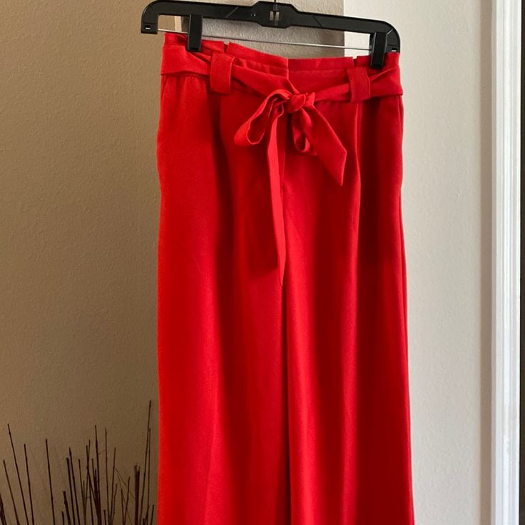 Elegant Express Pants With Wide Bottoms. Chic Red Bottoms For Spring, Elegant Red Summer Bottoms, Red Spring Workwear Bottoms, Red Bottoms For Spring Workwear, Red High Waist Bottoms For Spring, High Waist Red Bottoms For Spring, Red High-waist Bottoms For Spring, Red Long Pants For Spring, Chic Red Spring Bottoms