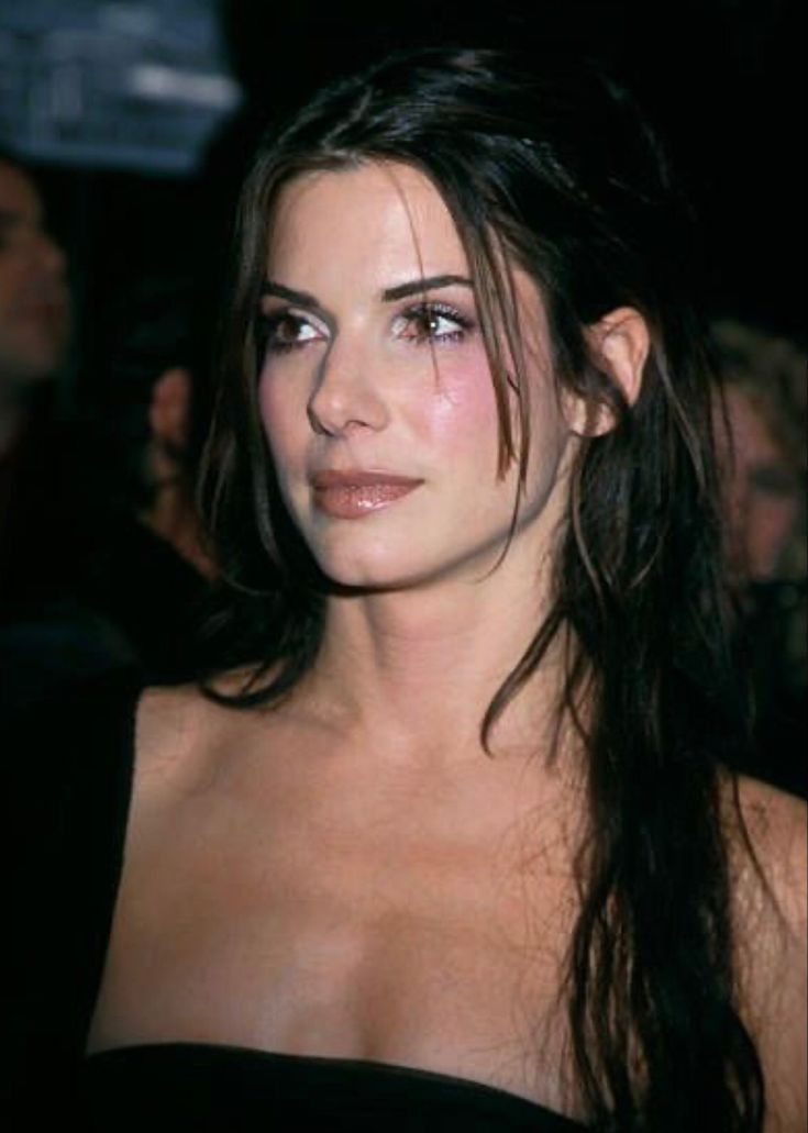 a woman with very long hair wearing a black dress