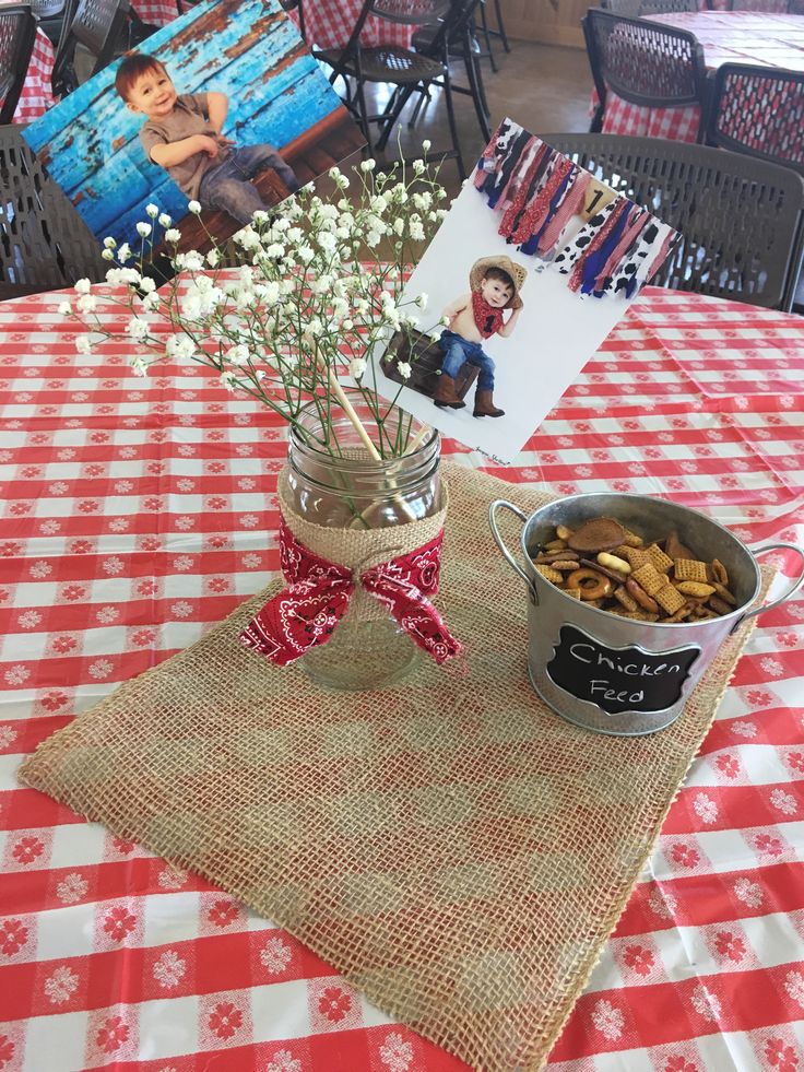 a table topped with a vase filled with baby's breath next to a bowl of chips