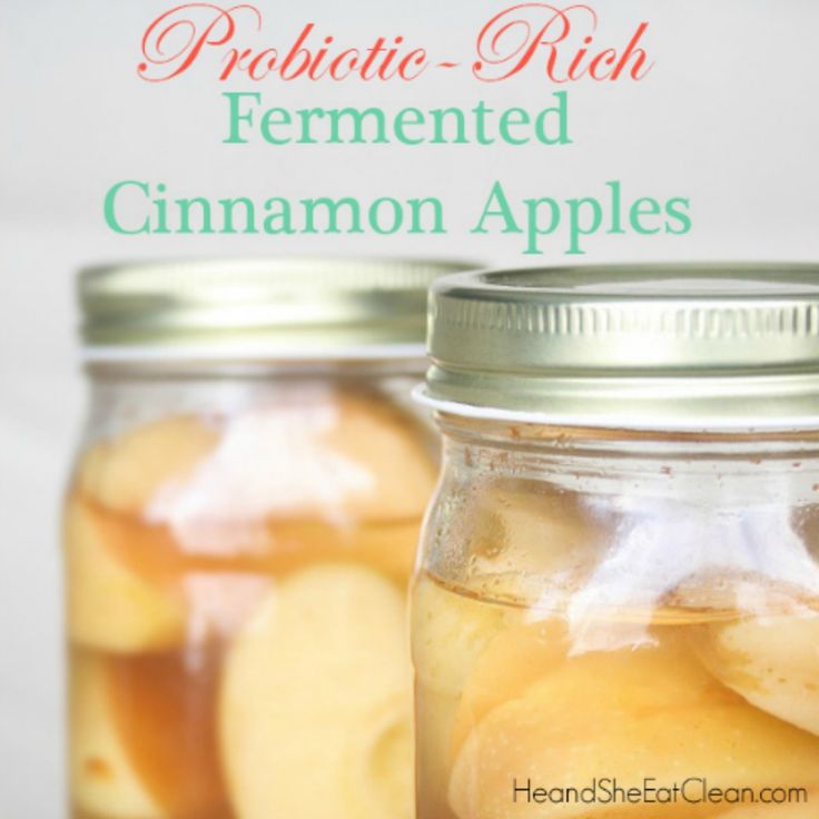 two mason jars filled with sliced apples on top of a table