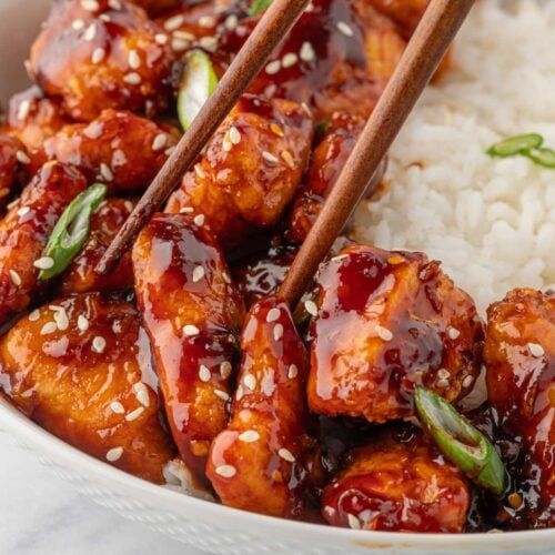 chicken and rice with chopsticks in a bowl