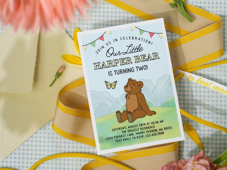 there is a card that says our little harper bear is turning two on it next to some flowers