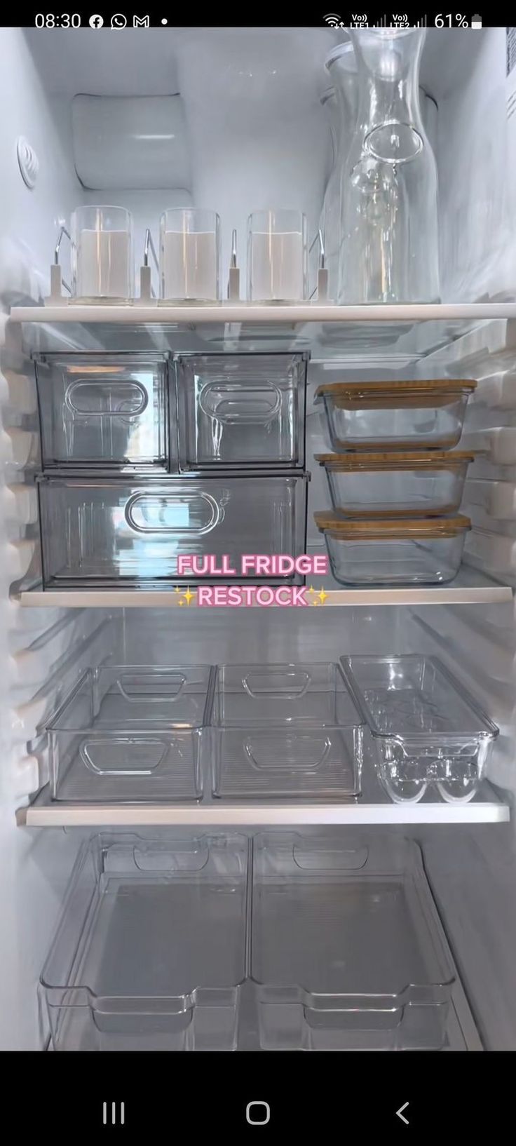 an open refrigerator with lots of plastic containers on the door and shelves filled with food