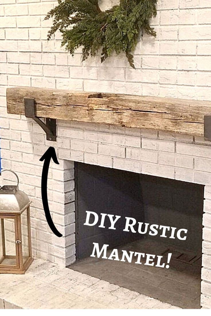 a white brick fireplace with the words diy rustic mantel on it and a wreath hanging above