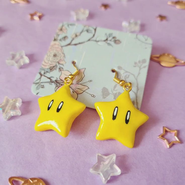 Cute Mario inspired earrings in the shape of the iconic power stars from the games. Handcrafted from polymer clay, painted with metallic yellow acrylic for a little extra sparkle, and finished with a spray of gloss for shine. Now you too can power up on your way to save Princess Peach from Bowser's clutches International customers: Please be advised that additional customs charges may be applied upon entry and these charges are your responsibility to pay. I have no knowledge of if, when, or how Princesa Peach, Power Star, Cute Galaxy Wallpaper, Polymer Clay Animals, Diy Clay, Gift Decorations, Ear Jewelry, Friend Birthday, Star Earrings