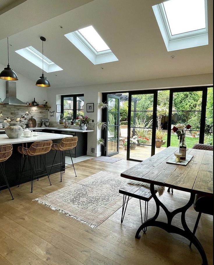 an open kitchen and dining room with skylights