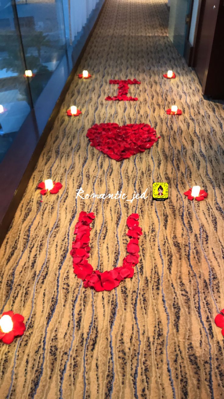 the hallway is decorated with red flowers and candles for valentine's day celebrations,