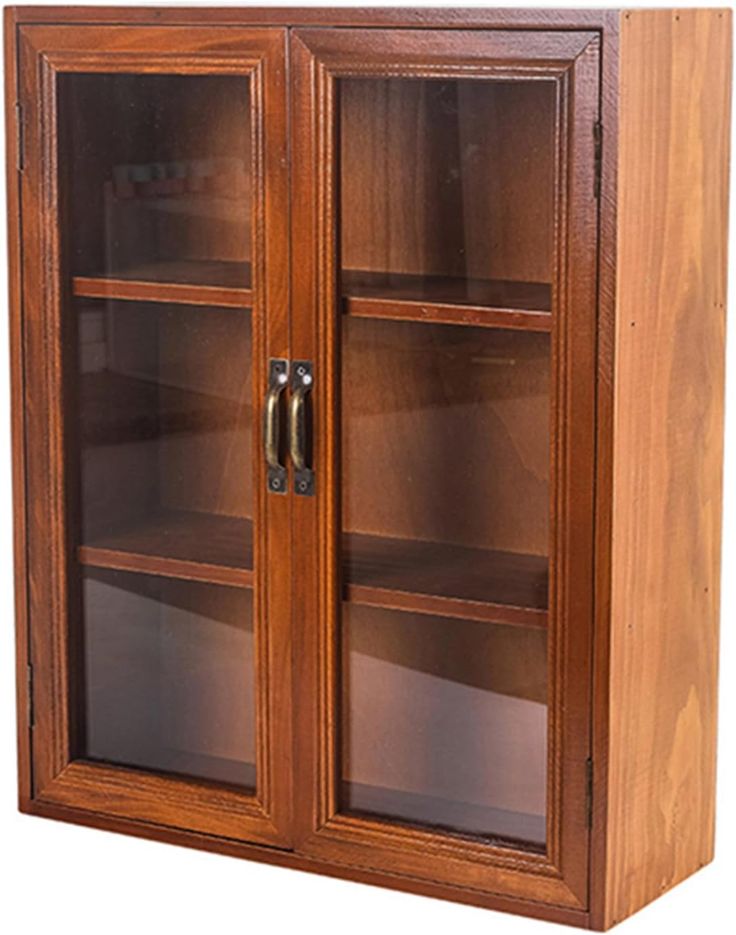 a wooden bookcase with glass doors on the front and bottom shelves in different sizes