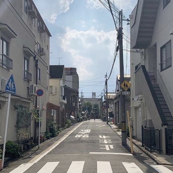 an empty city street lined with tall buildings