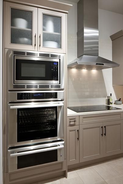 a kitchen with stainless steel appliances and cabinets