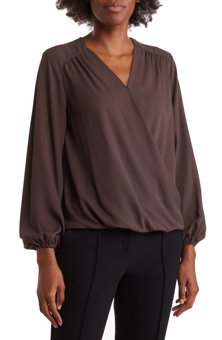 A long-sleeve blouse offers contemporary style with a gracefully draped faux-wrap silhouette and curved high-low hem. Surplice V-neck Long sleeves Draped wrap front Lightweight woven construction High-low hem 100% polyester Machine wash, tumble dry Imported Model stats: 5'10" height, 32" bust, 25" waist, 36" hip. Model is wearing size S. Texas Style, High Low Hem, Wrap Blouse, Contemporary Style, Long Sleeve Blouse, Nordstrom, Long Sleeve, Women's Top, How To Wear