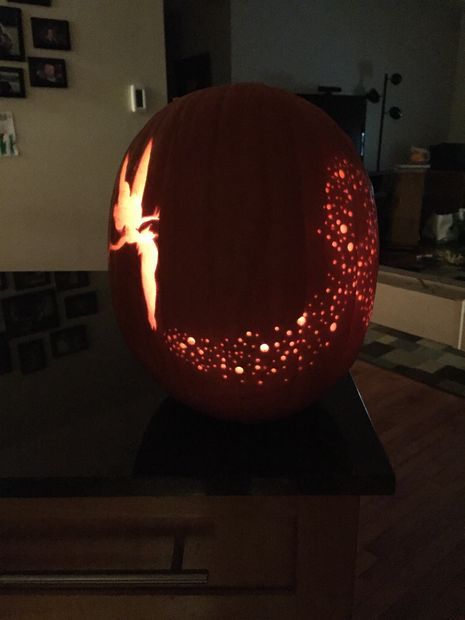 a carved pumpkin with a bird on it