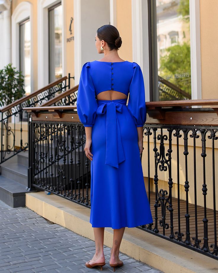 Round neckline Puff sleeves Short sleeves Backless Zipper on back Button detailed Tie detailed Midi length Dress length: 126cm/ 49.60 in Skirt length: 92 cm/ 36.22 in Sleeve length: 55 cm/ 21.65 in Blue Long Sleeve Puff Sleeve Dress For Brunch, Fitted Blue Puff Sleeve Dress With Pleated Sleeves, Tie-back Midi Dress With Puff Sleeves, Blue Long Sleeve Puff Sleeve Dress For Evening, Chic Blue Long Sleeve Puff Dress, Blue Fitted Puff Sleeve Dress With Balloon Sleeves, Elegant Puff Sleeve Dress With Tie Back, Party Puff Sleeve Dress With Tie Back, Blue Chic Puff Sleeve Dress With Pleated Sleeves