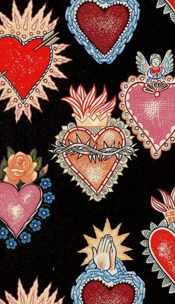 a black background with red and pink heart designs on it's side, next to a ruler