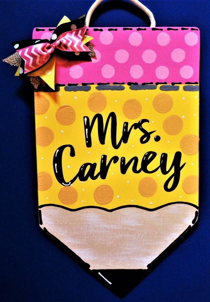 a paper bag with the words mrs carney on it and a bow hanging from it