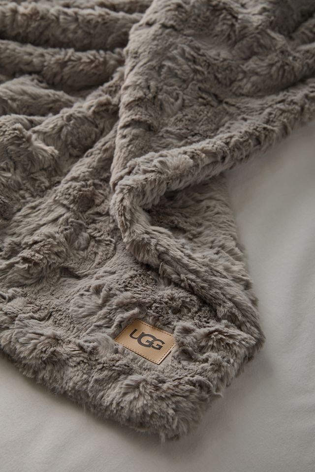 a bed with a blanket that has the number 60 on it and is made out of fluffy fur