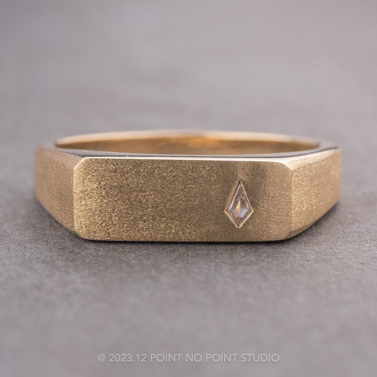 a gold ring with a diamond on it