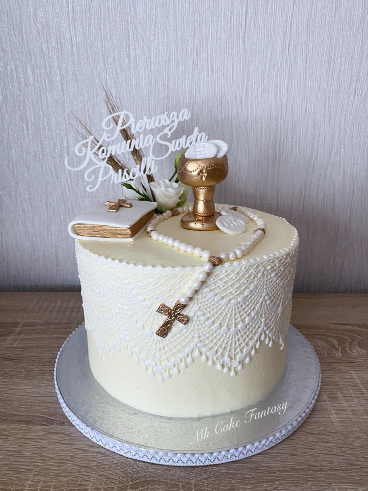 a cake decorated with white frosting and gold decorations