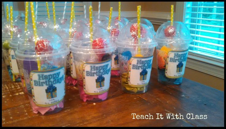 plastic cups filled with birthday candles on top of a table