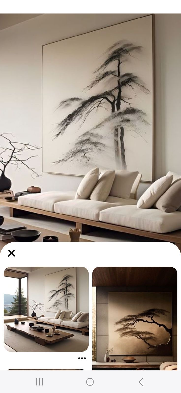 a living room filled with furniture and paintings on the wall above it's coffee table