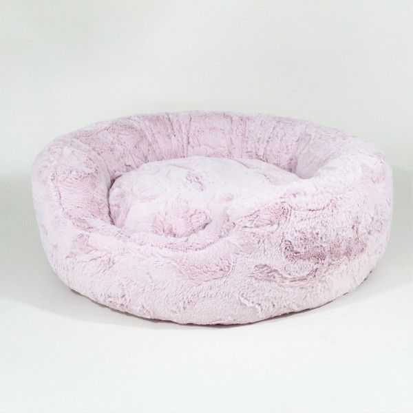 a pink dog bed on a white background