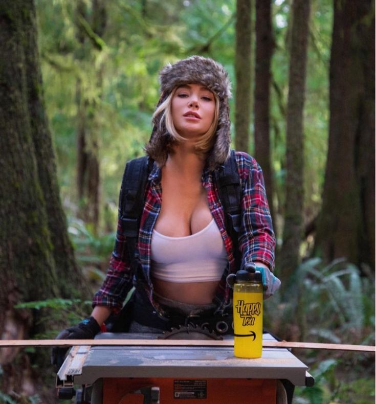 a woman standing on top of a table in the woods