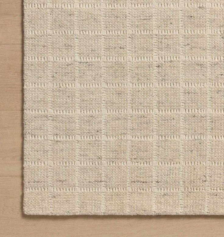 a beige rug with white squares on it