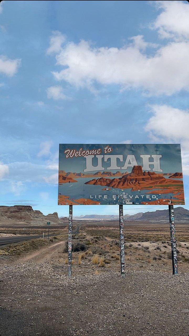 a welcome to utah sign in the desert