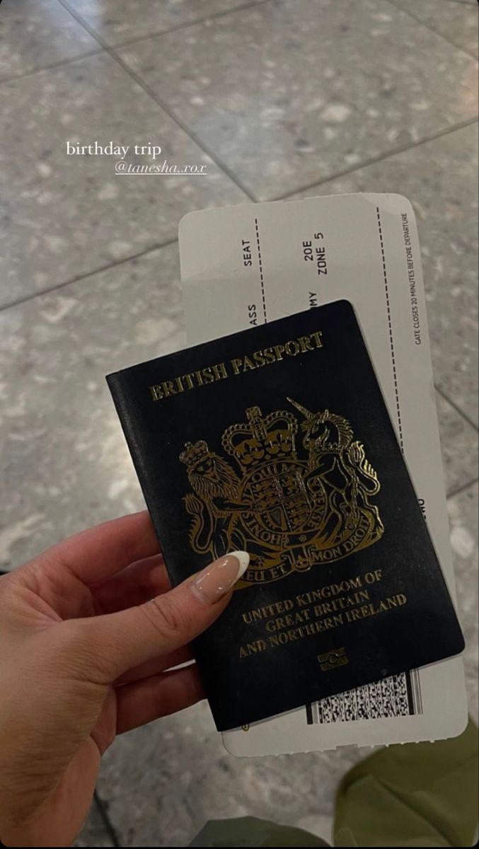 a person holding up a british passport in front of a tiled floor with the words british passport written on it