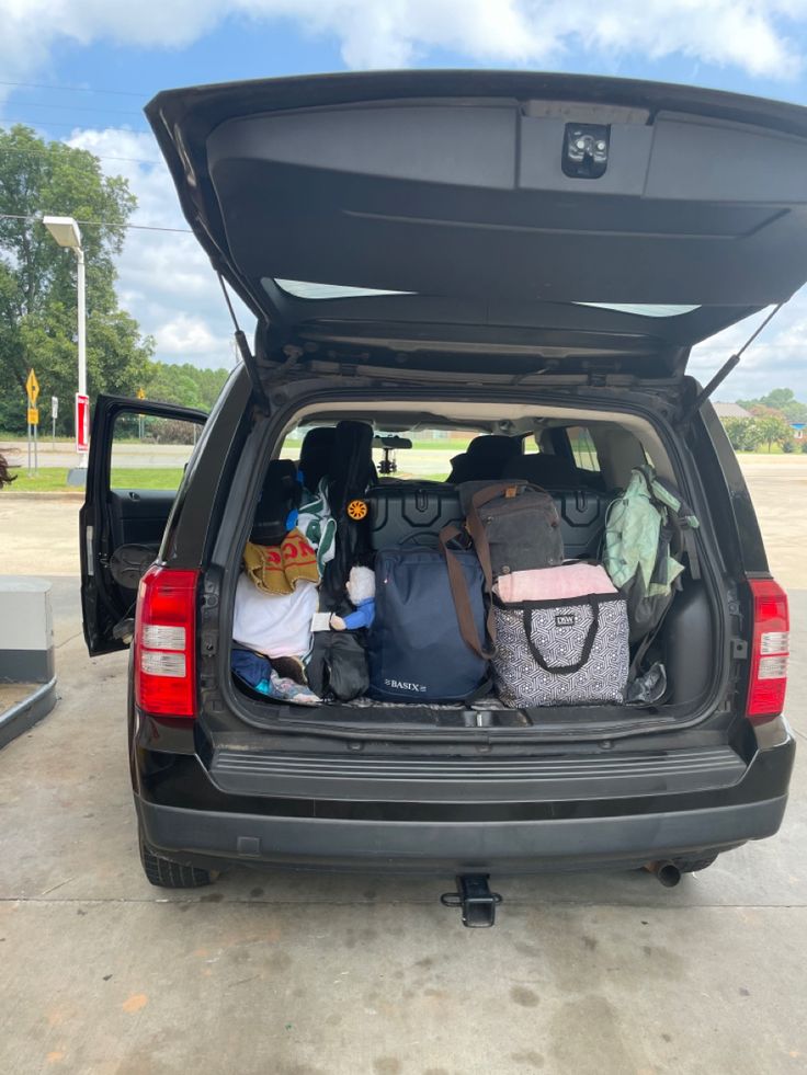 the back end of a van filled with luggage