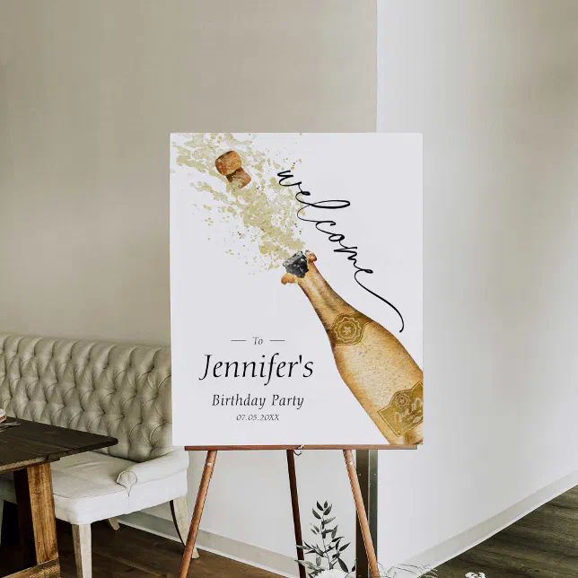 a birthday party sign on an easel in front of a couch