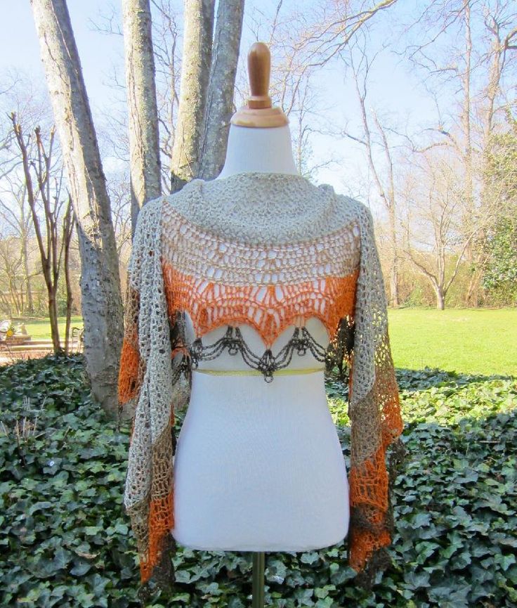 a white mannequin with an orange and gray crochet top on it