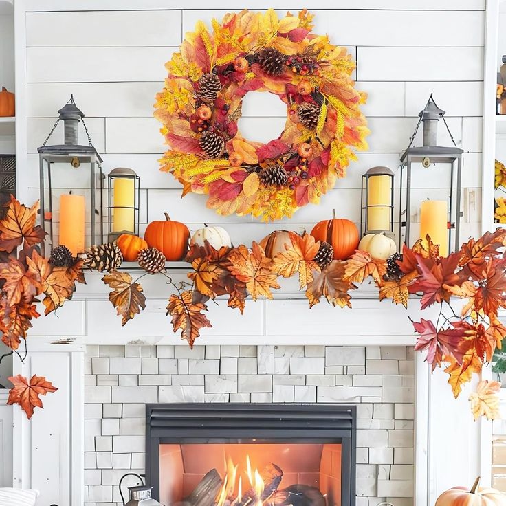 a fireplace decorated with fall leaves and candles