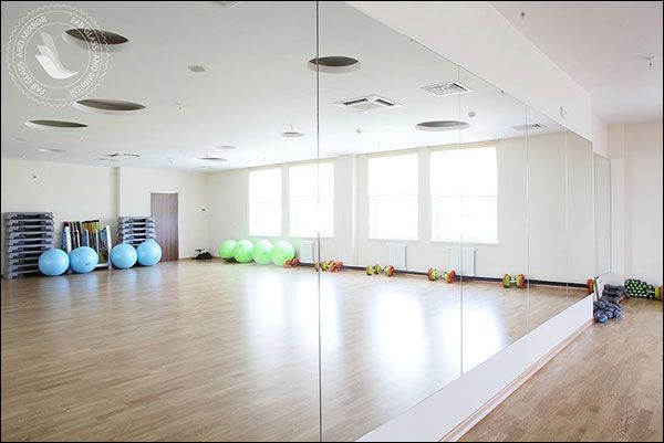 an empty gym with mirrors and exercise balls